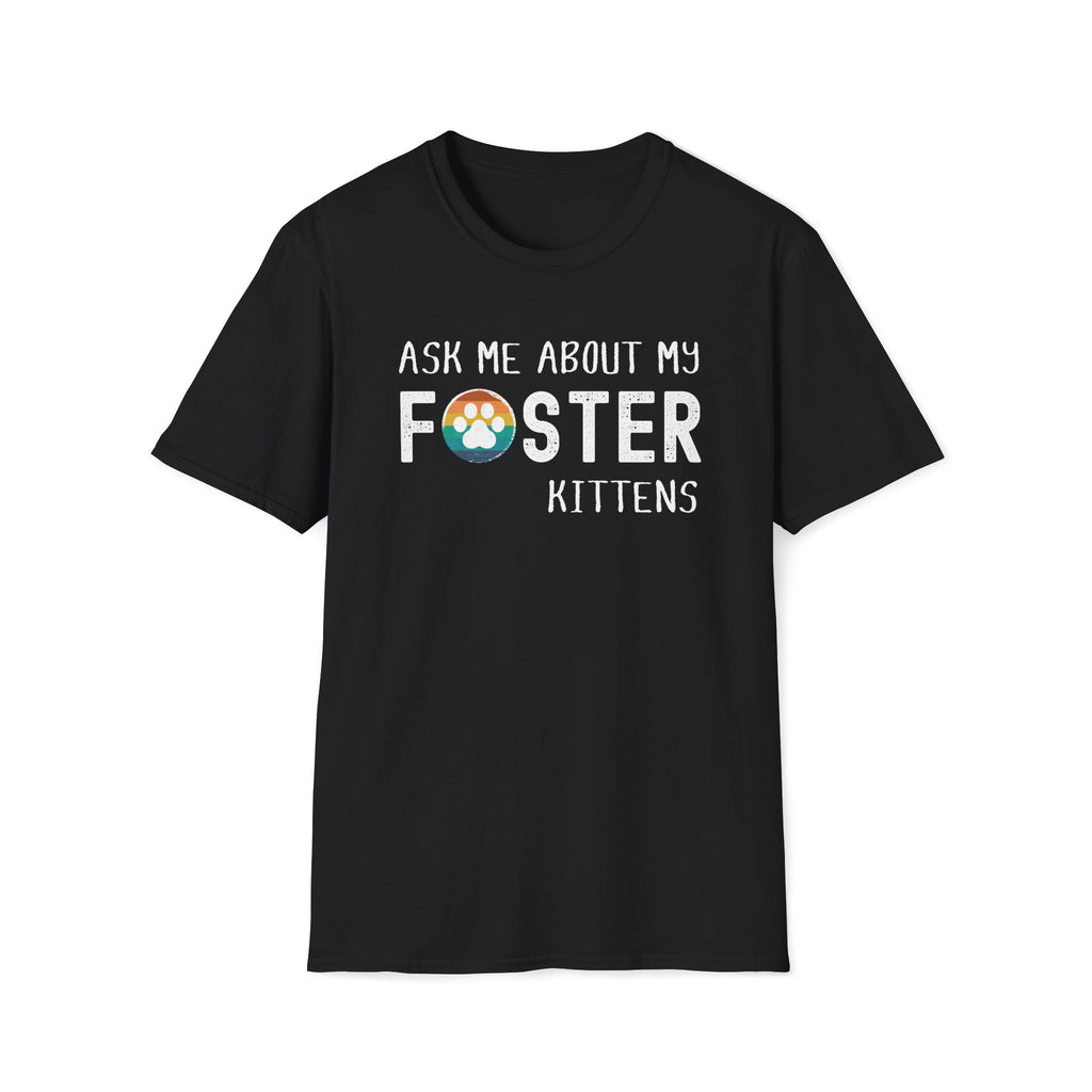 Black soft t-shirt with text that reads ‘Ask Me About My Foster Kittens’ and a retro styled rainbow paw-print graphic in the word Foster