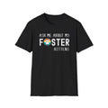 Black soft t-shirt with text that reads ‘Ask Me About My Foster Kittens’ and a retro styled rainbow paw-print graphic in the word Foster
