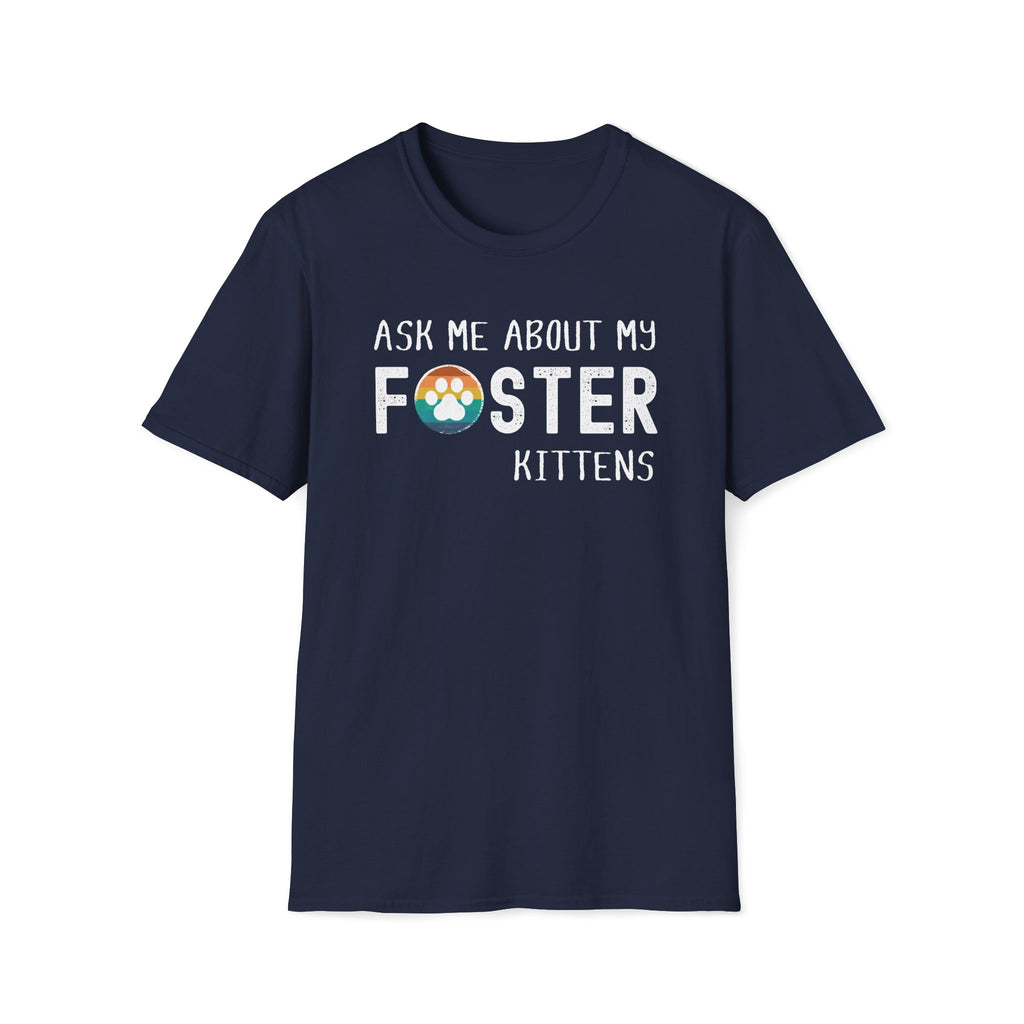 Navy soft t-shirt with text that reads ‘Ask Me About My Foster Kittens’ and a retro styled rainbow paw-print graphic in the word Foster