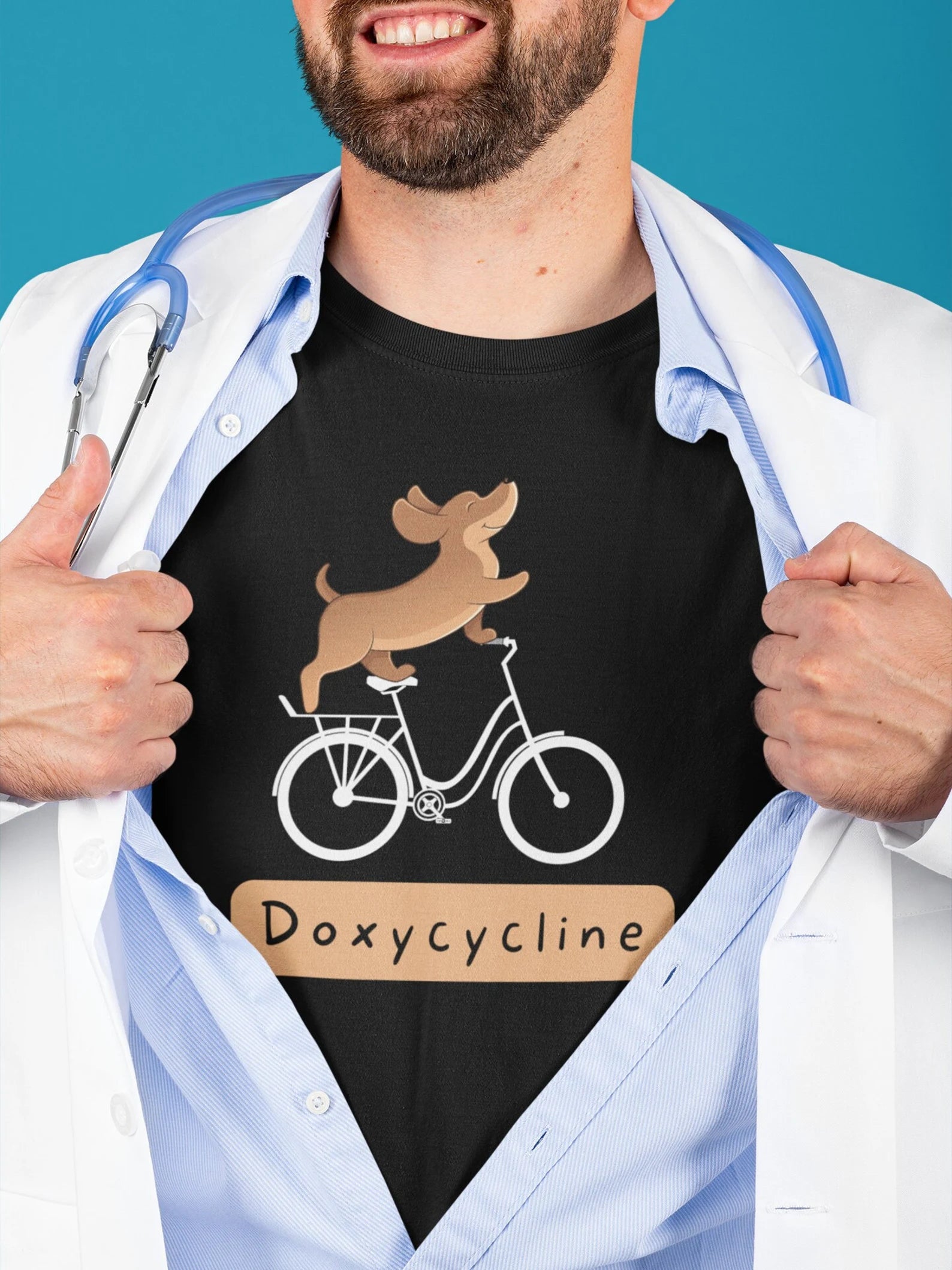 Veterinarian Vet Tech Spay Neuter Staff wearing a lab coat and stethoscope over a turquoise t-shirt with a cartoon dog riding a bicycle and the word ‘Doxycycline.’ Cute vet-med pun shirt