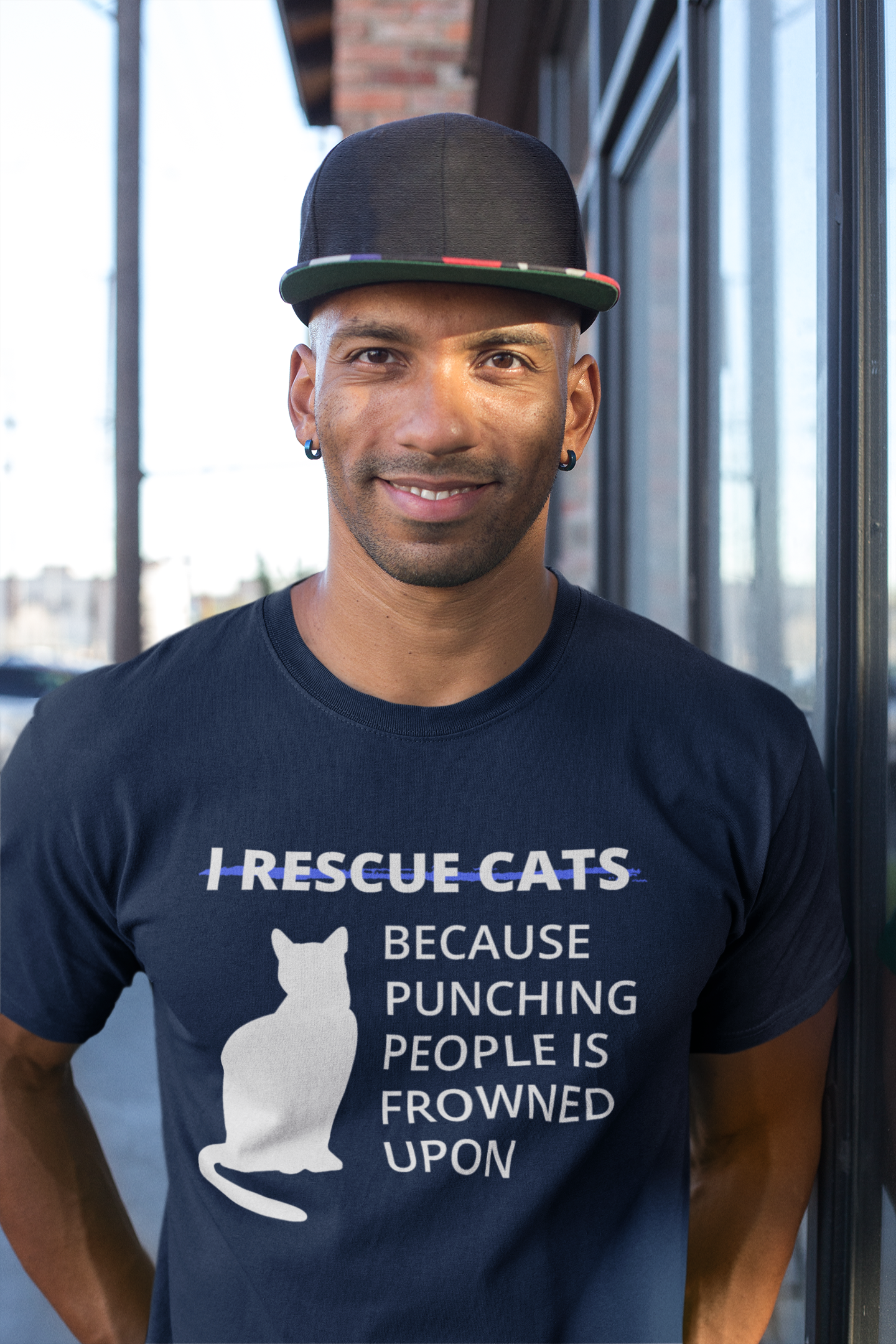 Man wearing a navy shirt with cat bold sassy text reads I rescue cats because punching people is frowned upon perfect for animal rescue or tnr
