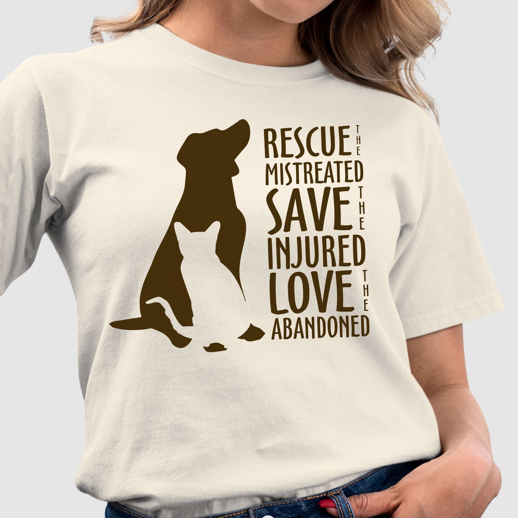 Woman wearing a natural colored tshirt that reads in bold chocolate brown print Rescue The Mistreated Save the Injured Love the Abandoned featuring a dog and cat image appealing to animal rescue, dog rescue, cat rescue, tnr advocates or animal lovers