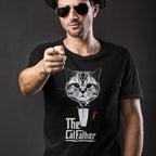 Man with a hat looking like a tough guy wearing a black tshirt with cat dressed in black tuxedo with red rose in the style of the classic movie bold stylized print reads The Cat Father 